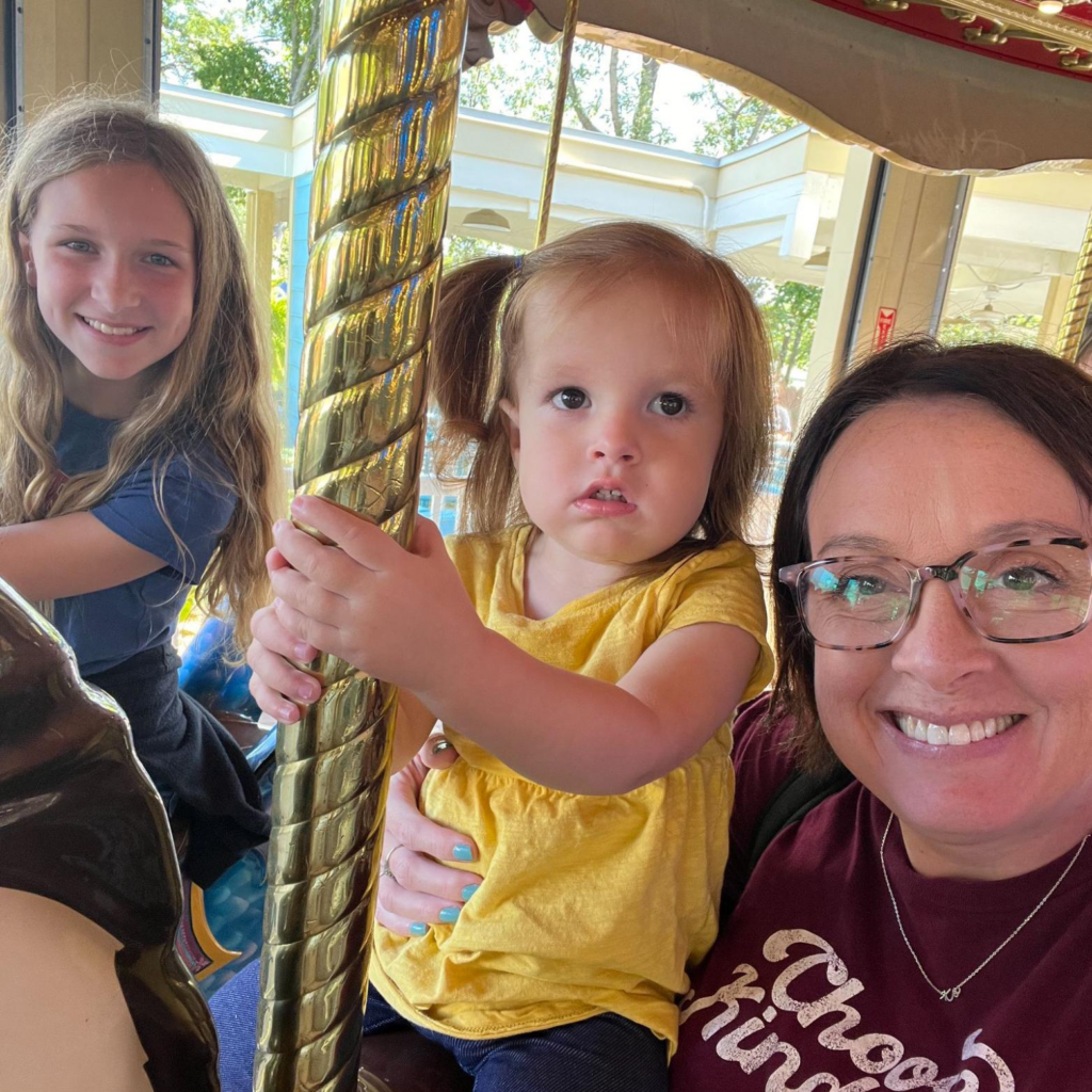 HoliBlogger Tara and her daughters on the carousel