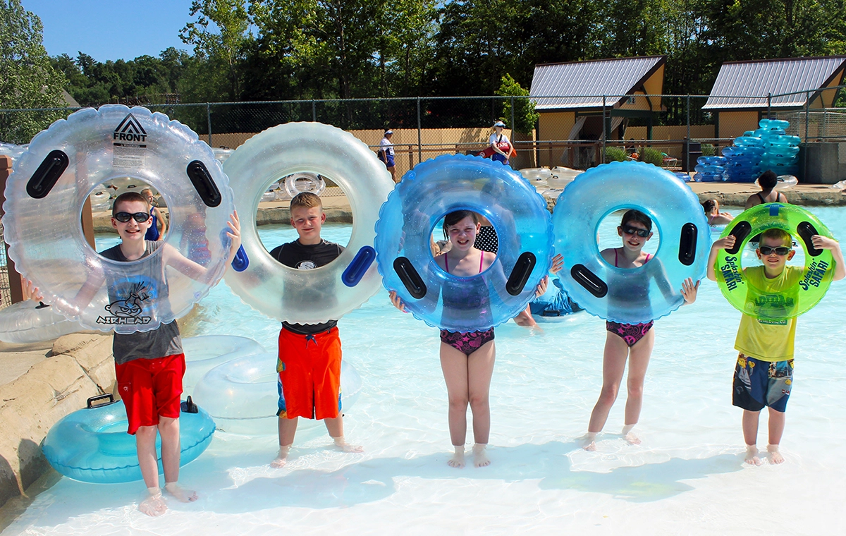 A group of five children showing off the different sizes of innertubes available on Bahari River lazy river at Holiday World & Splashin' Safari in Santa Claus, Indiana.