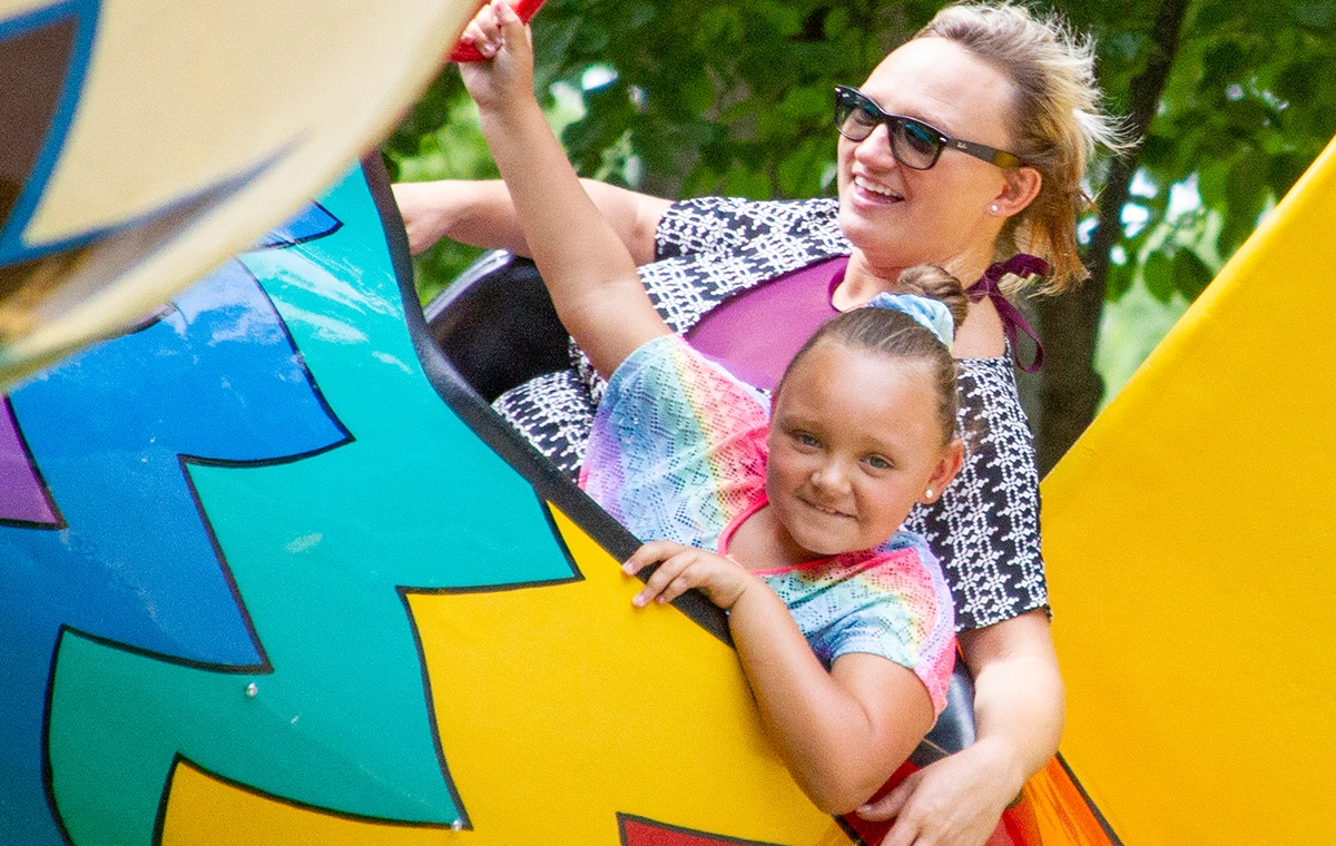 A mom and daughter fly in the multi-colored bird on Eagles Flight at Holiday World & Splashin' Safari in Santa Claus, Indiana.
