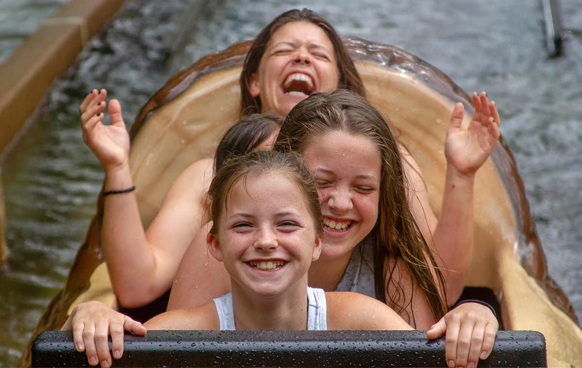 A boat full of girls laugh and smile after riding Frightful Falls at Holiday World & Splashin' Safari in Santa Claus, Indiana.