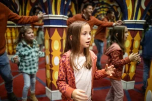 A family navigating the mirror maze inside Carnival Chaos at Holiday World during Happy Halloween Weekends.