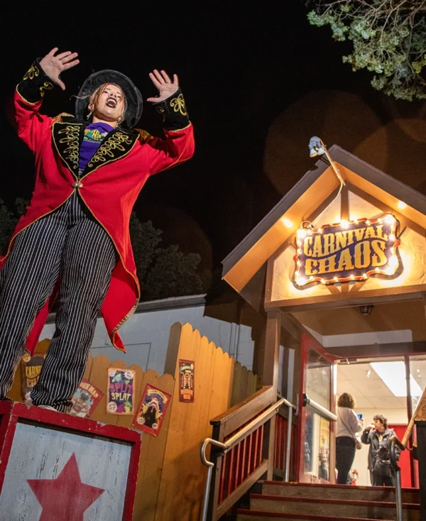 The carnival barker drumming up business outside Carnival Chaos at Holiday World during Happy Halloween Weekends