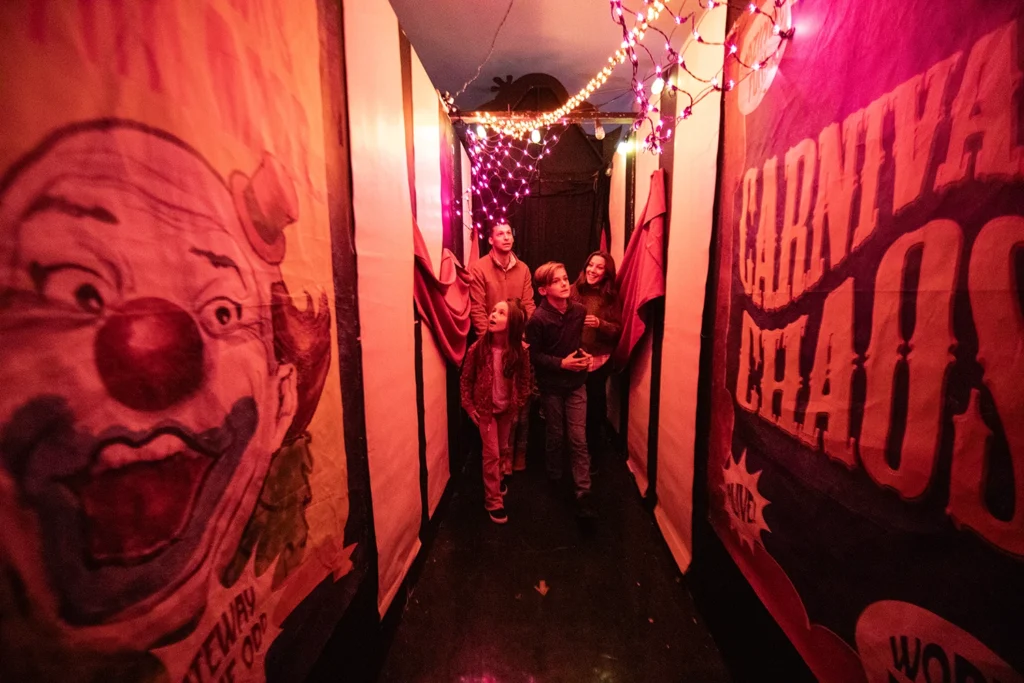 A family walks down a creepy hallway in Carnival Chaos at Holiday World during Happy Halloween Weekends