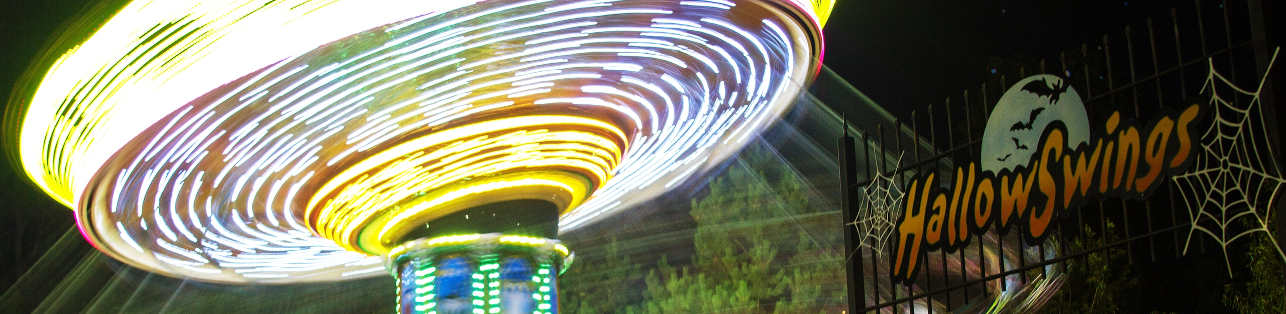 Night time long exposure showing light trails of HallowSwing's lighting package at Holiday World & Splashin' Safari in Santa Claus, Indiana.