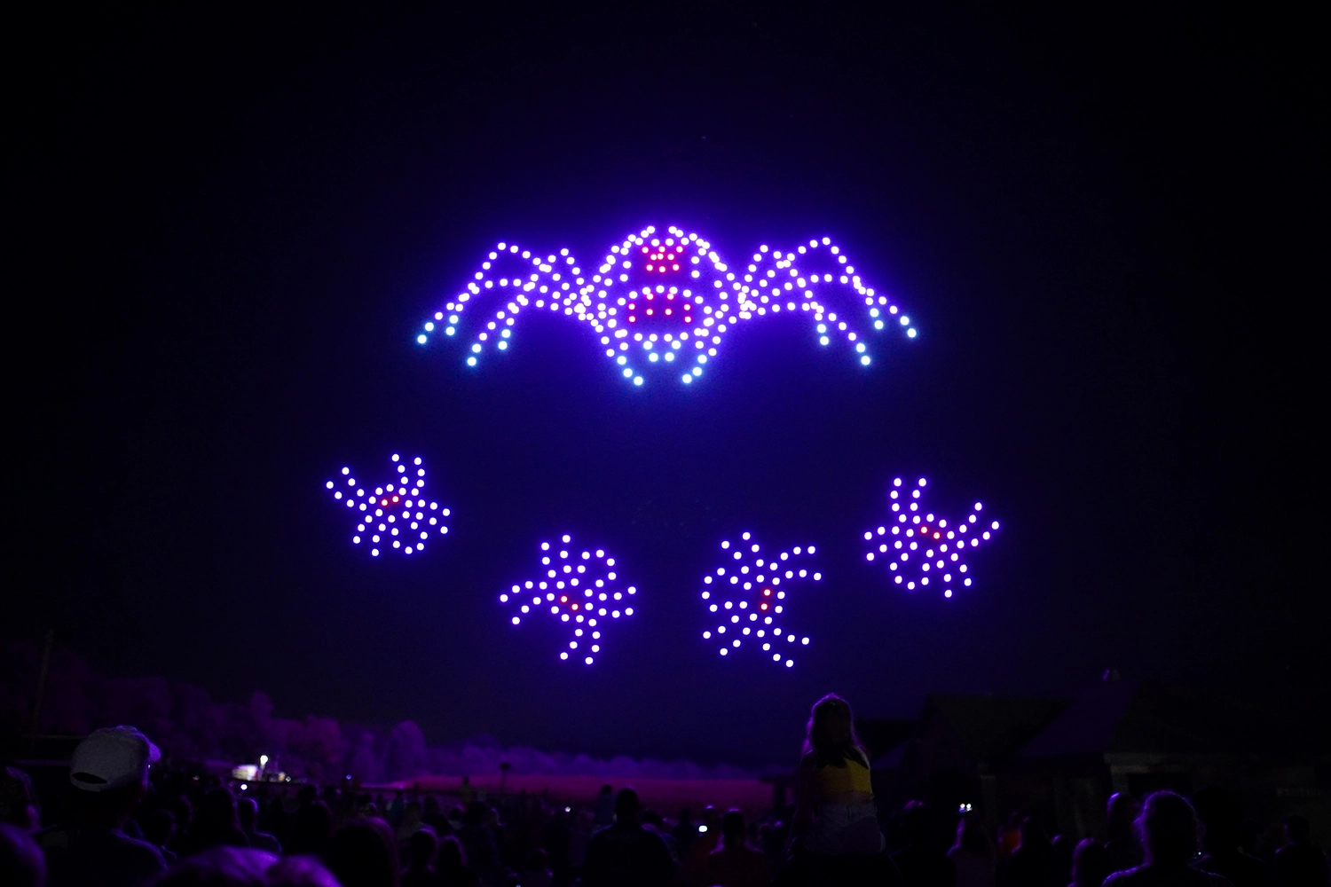 A family of large spiders made of drones during Halloween in the Sky at Holiday World.