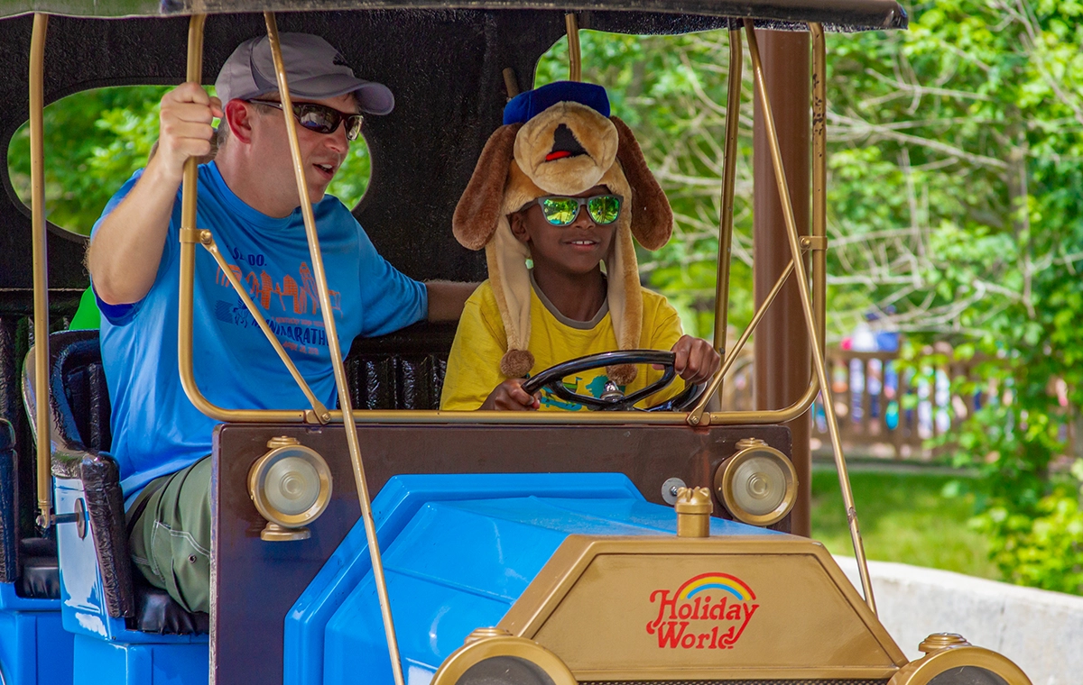 A youngster is getting a driving lesson on Lewis & Clark Trail at Holiday World & Splashin' Safari in Santa Claus, Indiana.