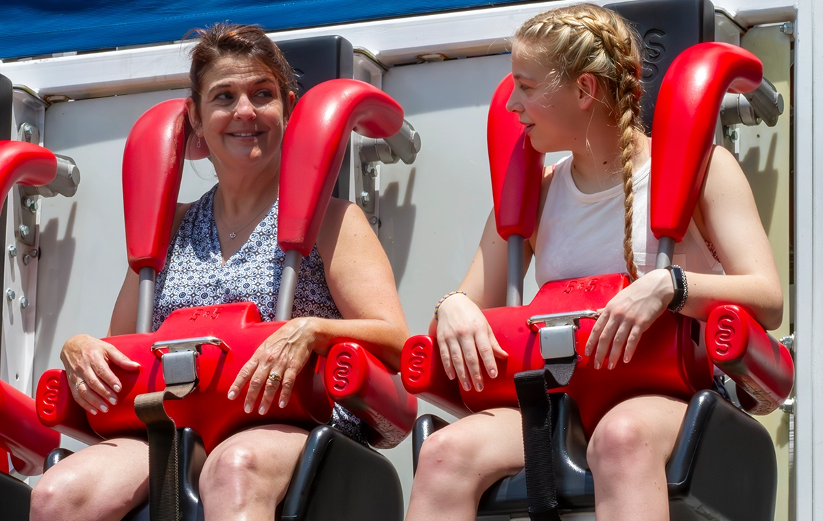 A mother and teenage daughter glance at each other before taking off on Liberty Launch at Holiday World & Splashin' Safari in Santa Claus, Indiana.