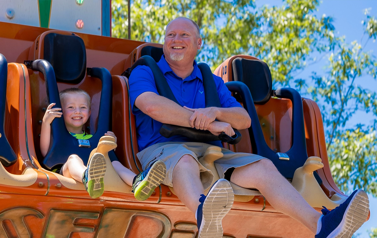 A father and son ride together on Reindeer Games at Holiday World & Splashin' Safari in Santa Claus, Indiana.