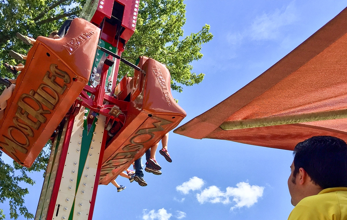 A ride operator looks up to observe Reindeer Games at Holiday World & Splashin' Safari in Santa Claus, Indiana.