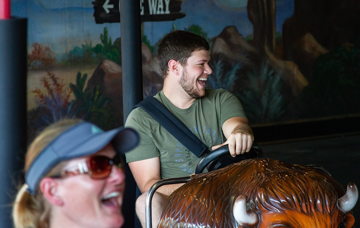 A man laughs at other drivers on Rough Riders at Holiday World & Splashin' Safari in Santa Claus, Indiana.