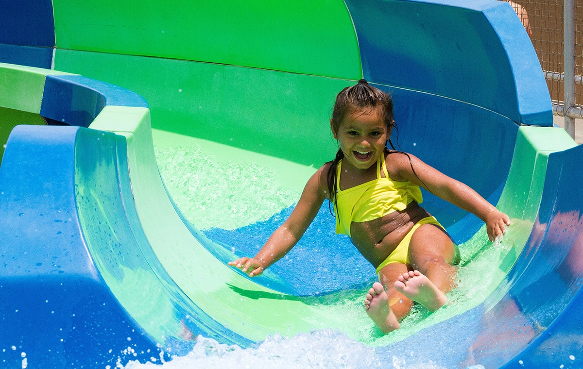 A young girl slides down one of the eight slides at Safari Sam's SplashLand at Holiday World & Splashin' Safari in Santa Claus, Indiana.