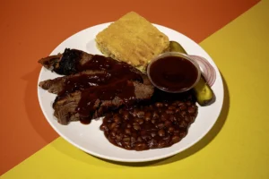 Plate Meal of BBQ Brisket with Baked Beans & Cornbread from Sam's Smokehouse at Holiday World & Splashin' Safari.