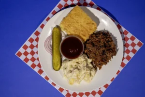 Plate Meal of Pulled Pork with Pepper Jack Mac & Cheese and Cornbread from Sam's Smokehouse at Holiday World & Splashin' Safari.