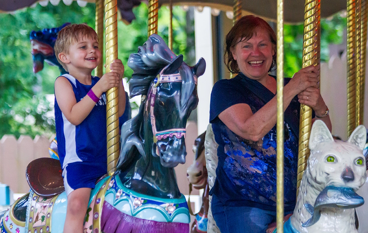 A grandmother and grandson smile during their ride on Star Spangled Carousel at Holiday World & Splashin' Safari in Santa Claus, Indiana.