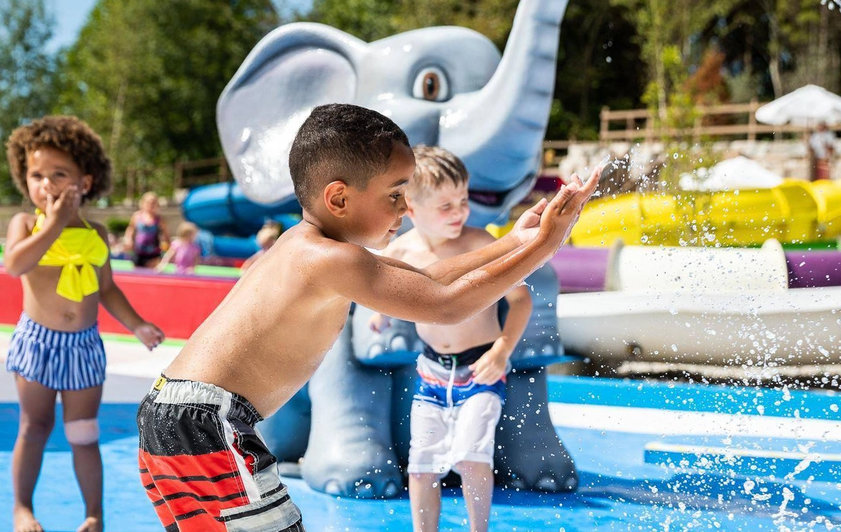 Kids splashing in the water features of Tembo Tides at Holiday World & Splashin' Safari in Santa Claus, Indiana.