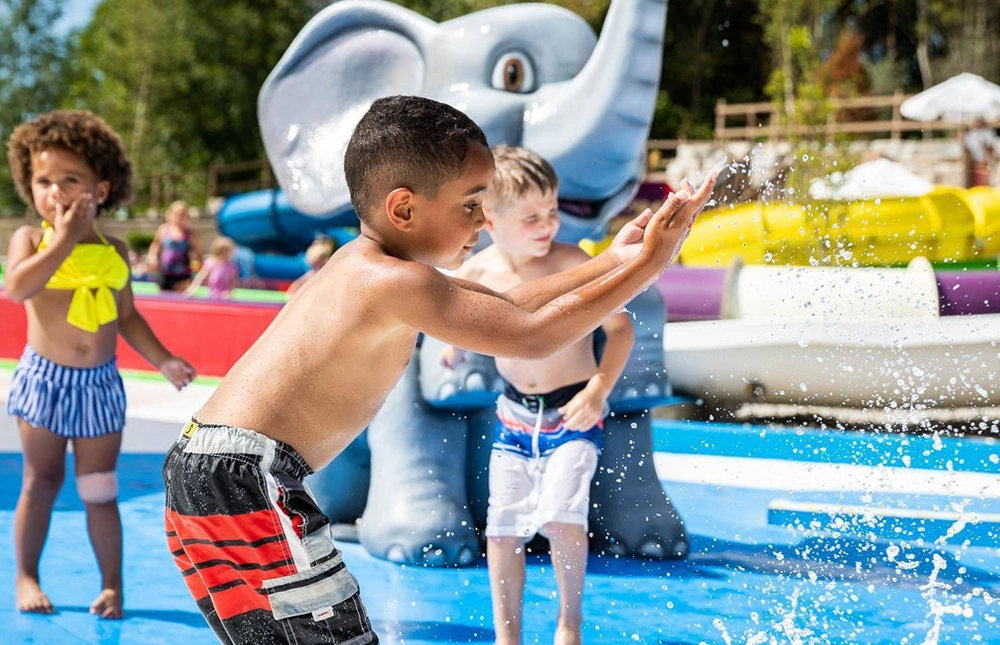Kids splashing in the water features of Tembo Tides at Holiday World & Splashin' Safari in Santa Claus, Indiana.