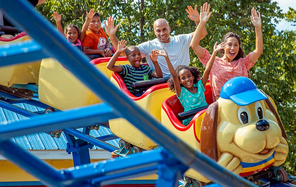 A train of riders with their hands up while riding The Howler at Holiday World & Splashin' Safari in Santa Claus, Indiana.