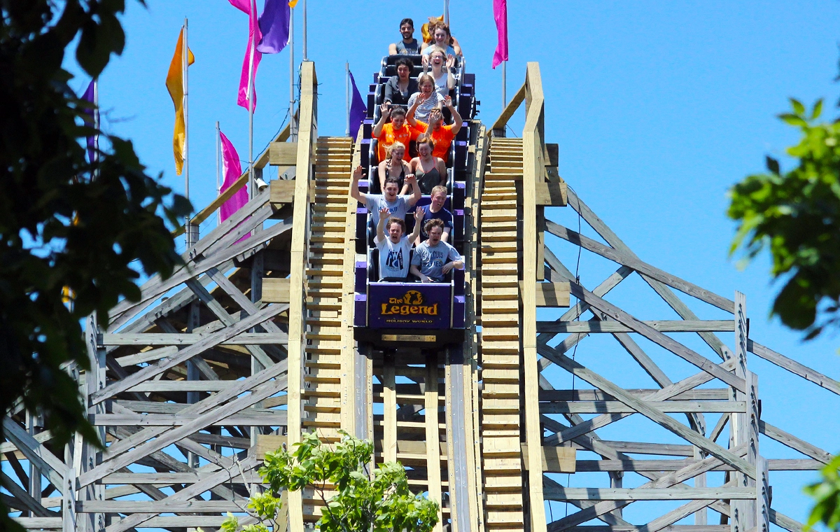 Riders cresting the first drop of The Legend Wooden Roller Coaster at Holiday World & Splashin' Safari in Santa Claus, Indiana.