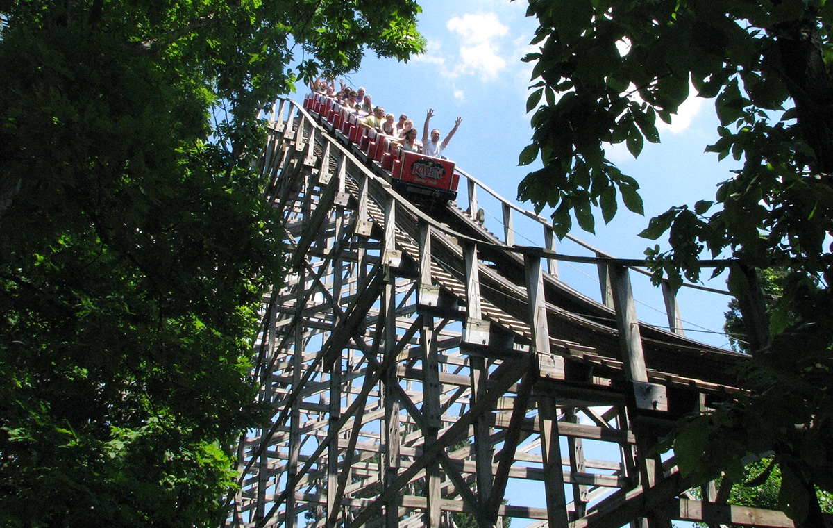 A train dropping down the first hill of The Raven at Holiday World & Splashin' Safari in Santa Claus, Indiana