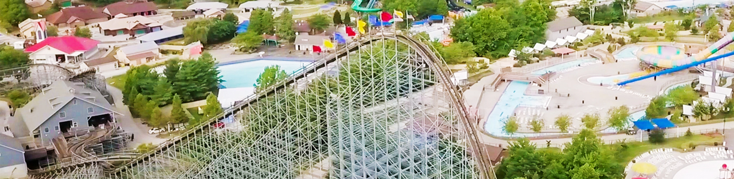 Aerial photo of The Voyage Wooden Roller Coaster's lift hill with water attractions in the background at Holiday World & Splashin' Safari in Santa Claus, Indiana