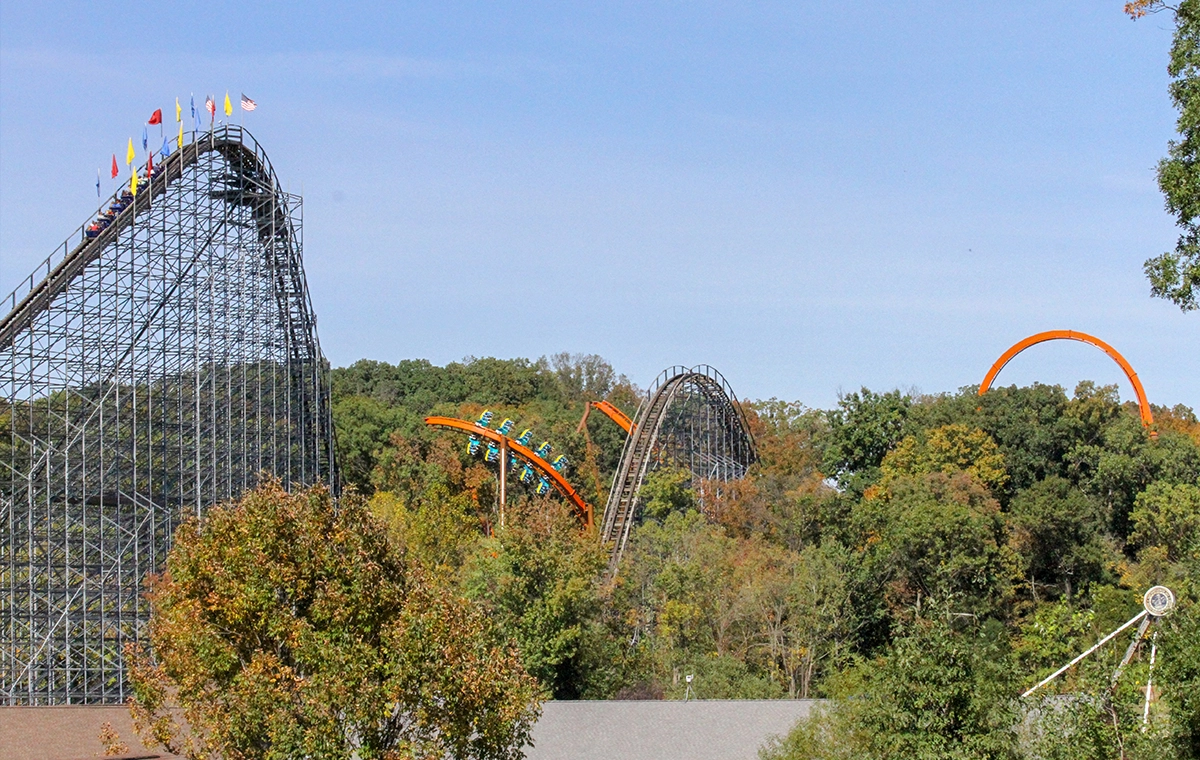 Peaceful image of The Voyage Wooden Roller Coaster along with Thunderbird Steel Roller Coaster and The Mayflower with many trees at Holiday World & Splashin' Safari in Santa Claus, Indiana
