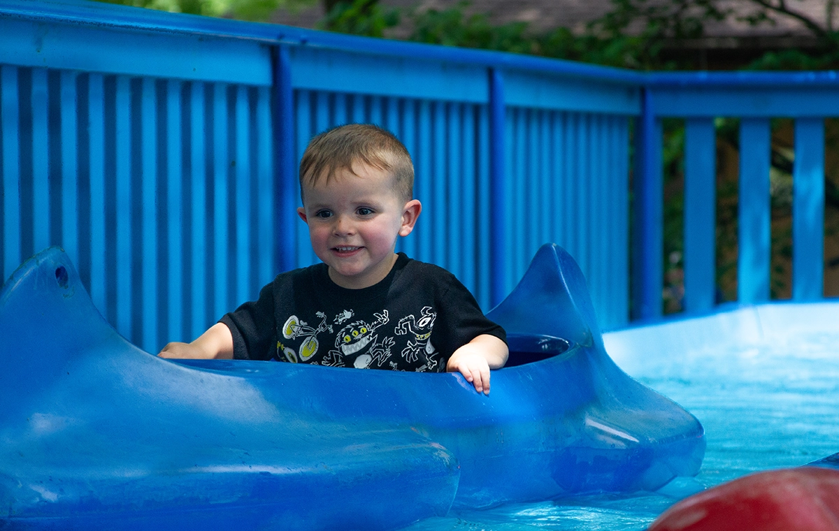 A small boy smiles as he floats along in Tippecanoes at Holiday World & Splashin' Safari in Santa Claus, Indiana.