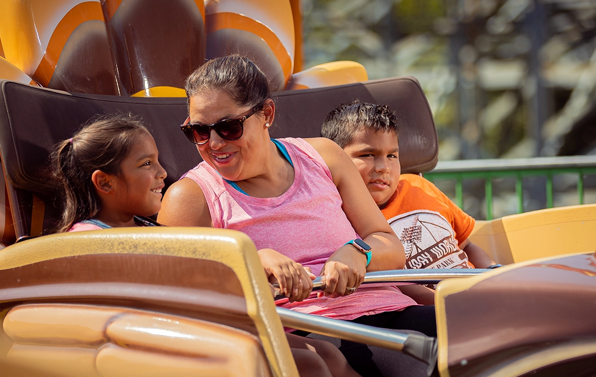 A mother gets ready to ride Turkey Whirl with two children at Holiday World & Splashin' Safari in Santa Claus, Indiana.