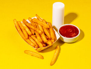 French Fries with Salt and Ketchup on a yellow background from Holiday World & Splashin' Safari in Santa Claus, Indiana