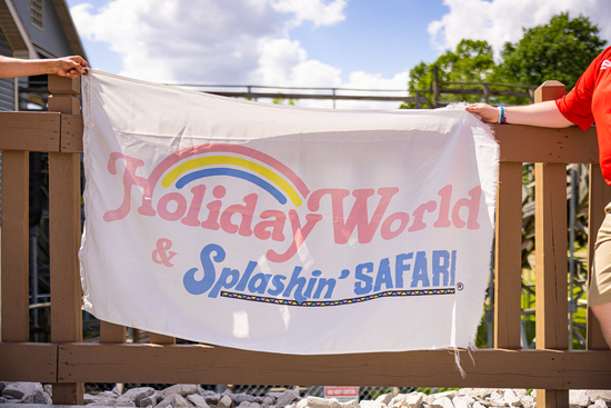 A white flag with the Holiday World & Splashin' Safari Logo printed on it.