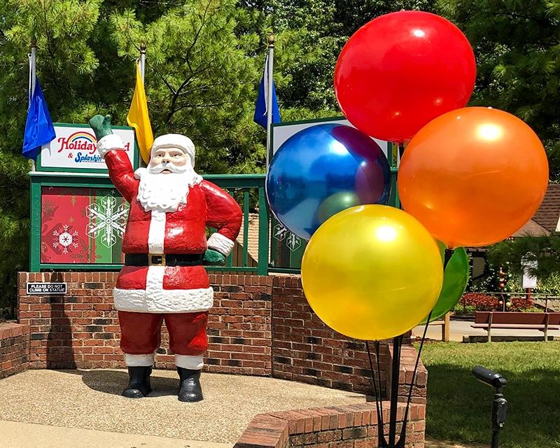 The Santa Statue with Kids World balloons in the foreground.