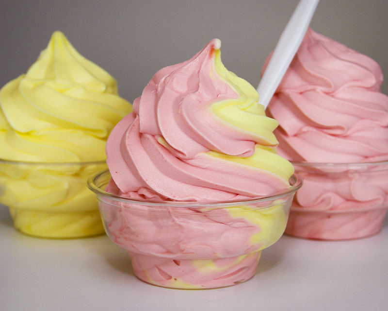Dole Whip soft serve in a cup. Featured are three options: pineapple, strawberry, and twist!