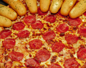 A pizza surrounded by breadsticks in the Family Meal Deal.