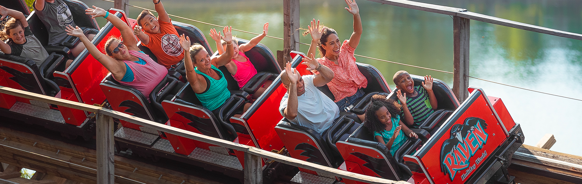A family rides the Raven roller coaster as it makes a sweeping turn over Lake Rudolph.