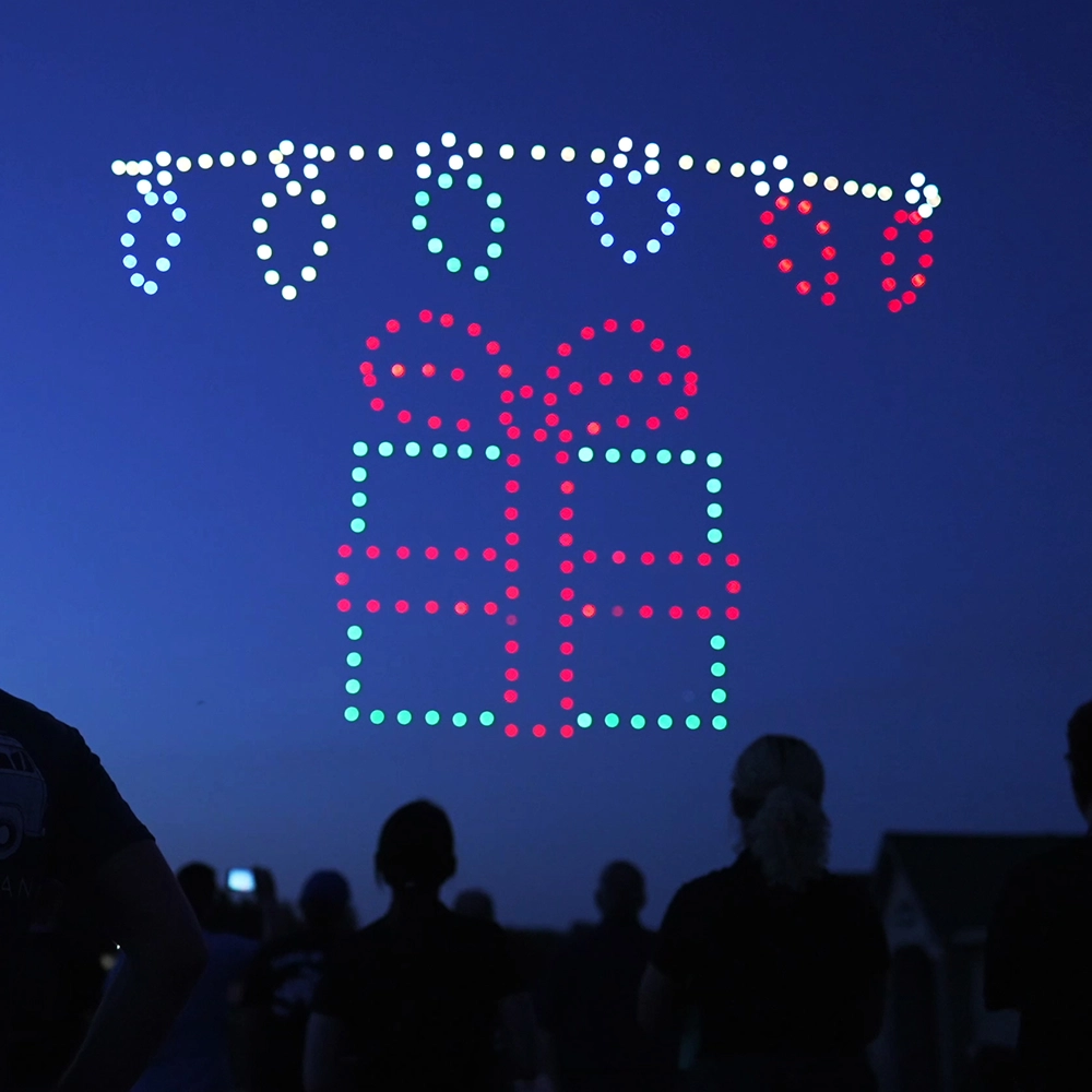 Drones make up a present with Christmas Lights hovering overhead during Holidays in the Sky.