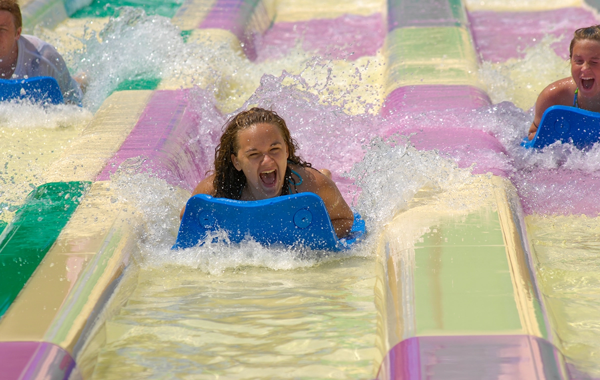 A teenage girl smiles as she splashes down on Jungle Racer at Holiday World & Splashin' Safari in Santa Claus, Indiana