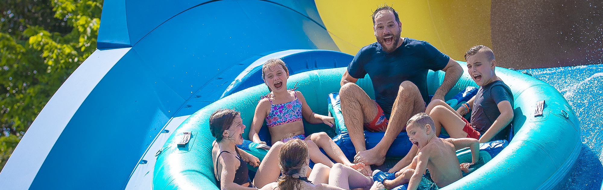 A family screams as they go over the top of a hill on Mammoth water coaster in Splashin' Safari.