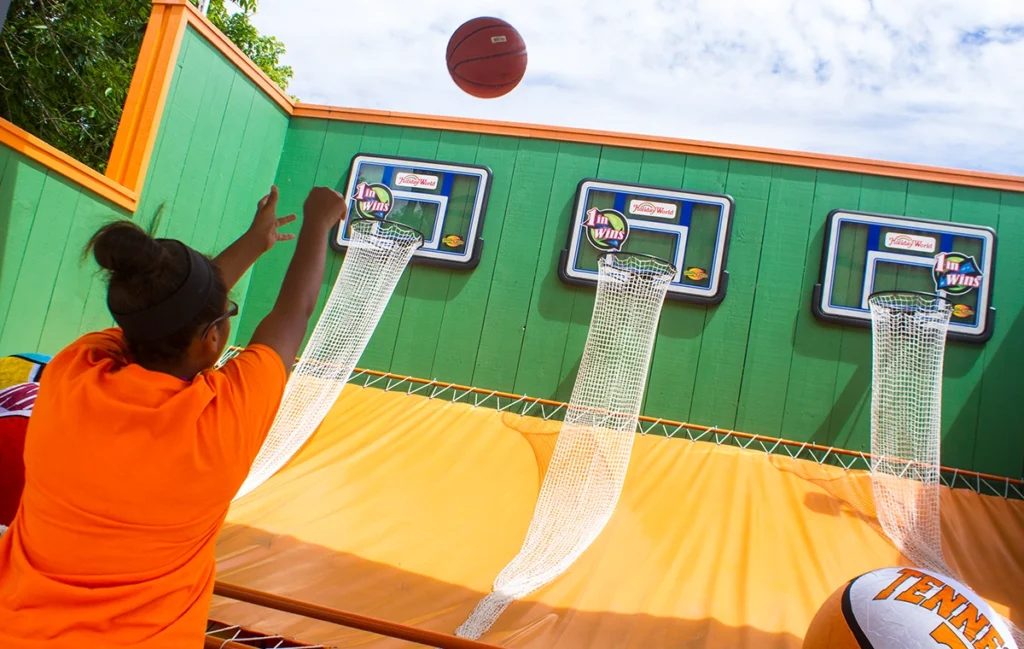 A young woman tests her accuracy at the Monster Ball Madness basketball game at Holiday World.