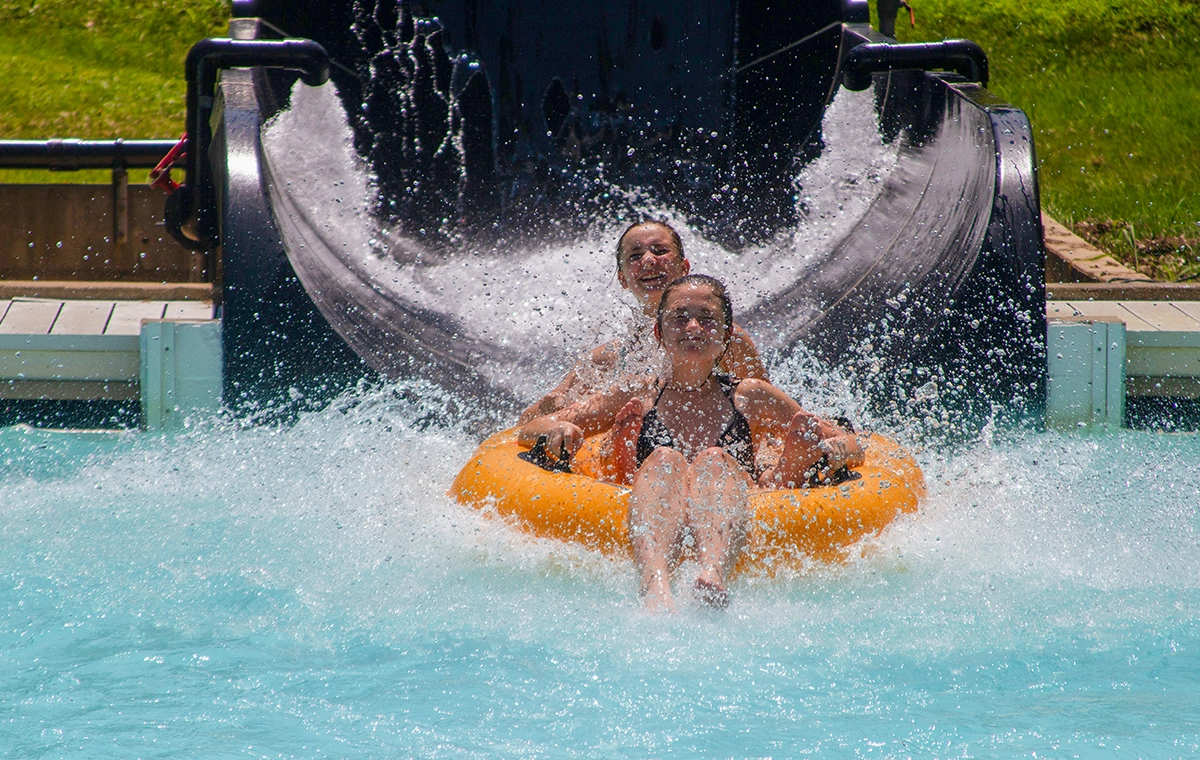 Two girls splashing down from the "Ron" slide of Otorongo at Holiday World & Splashin' Safari in Santa Claus, Indiana.