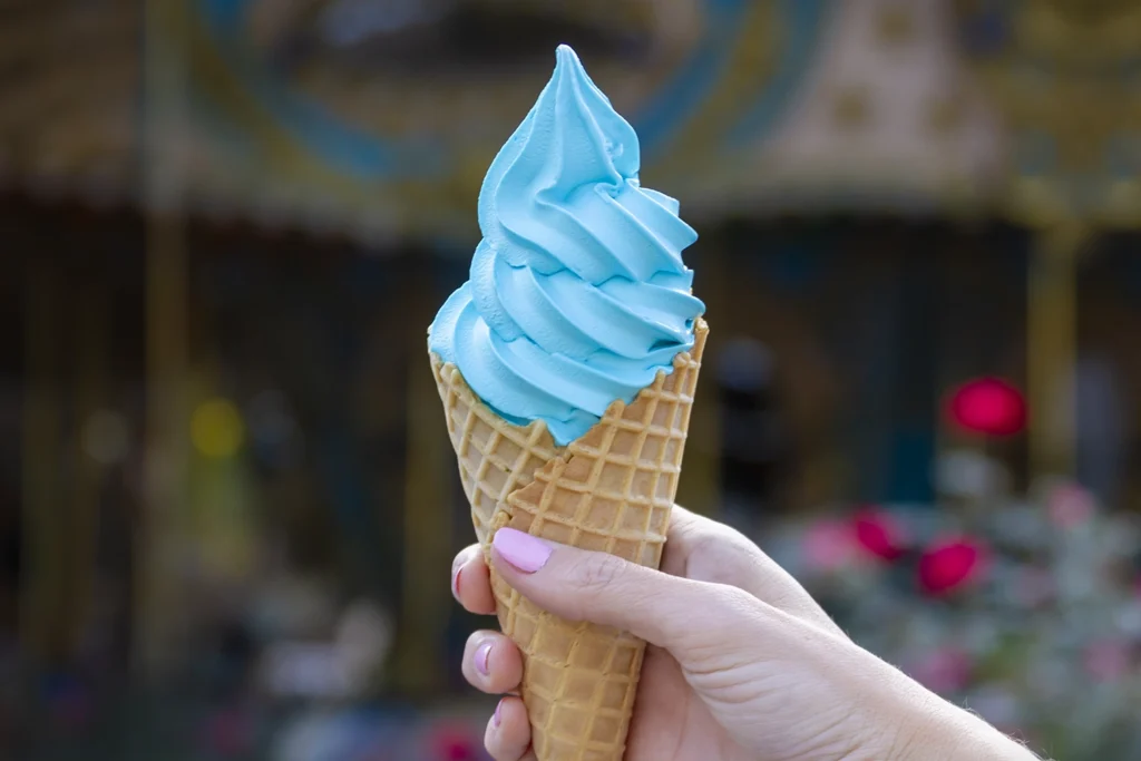 Udderly Blue Ice Cream in a Waffle Cone in front of Star Spangled Carousel at Holiday World.