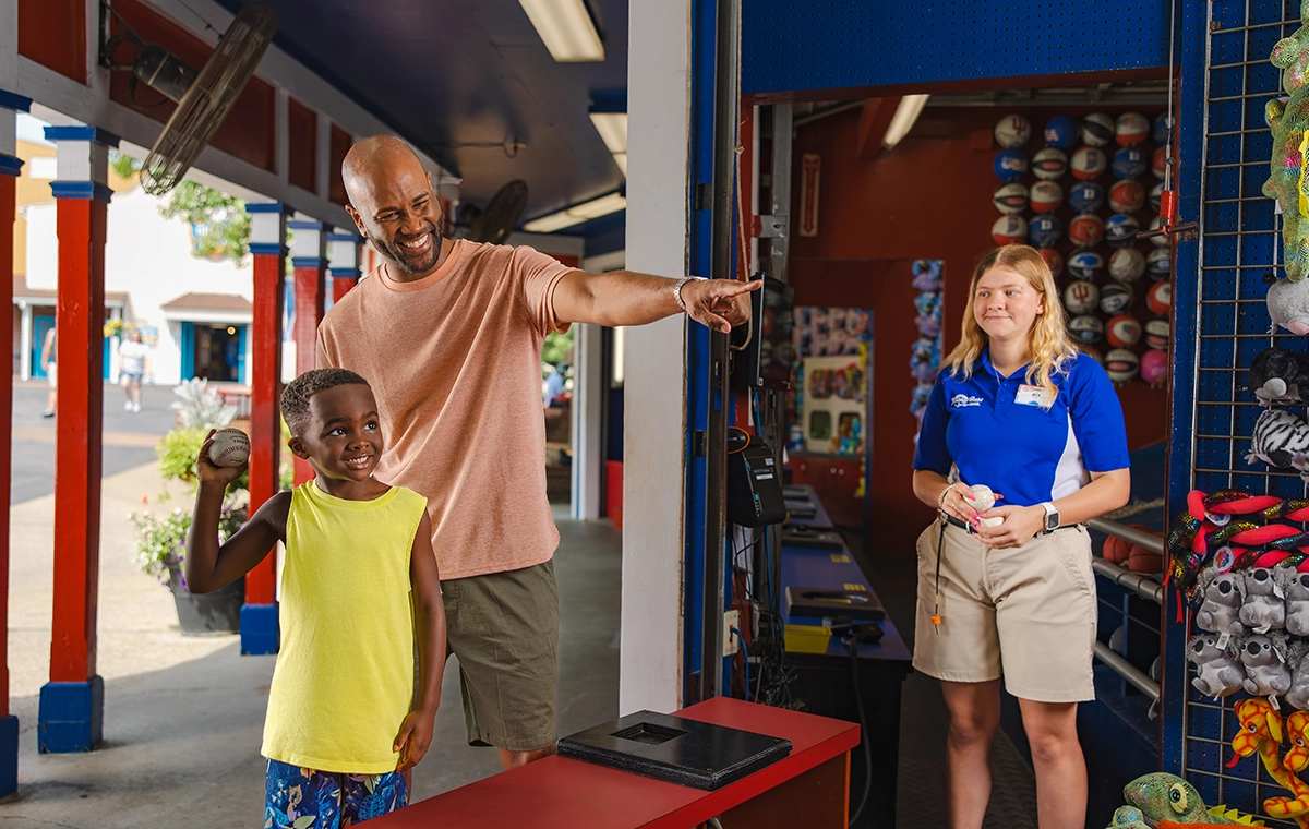 A father coaches his son who plays Wacky Cats at Holiday World.