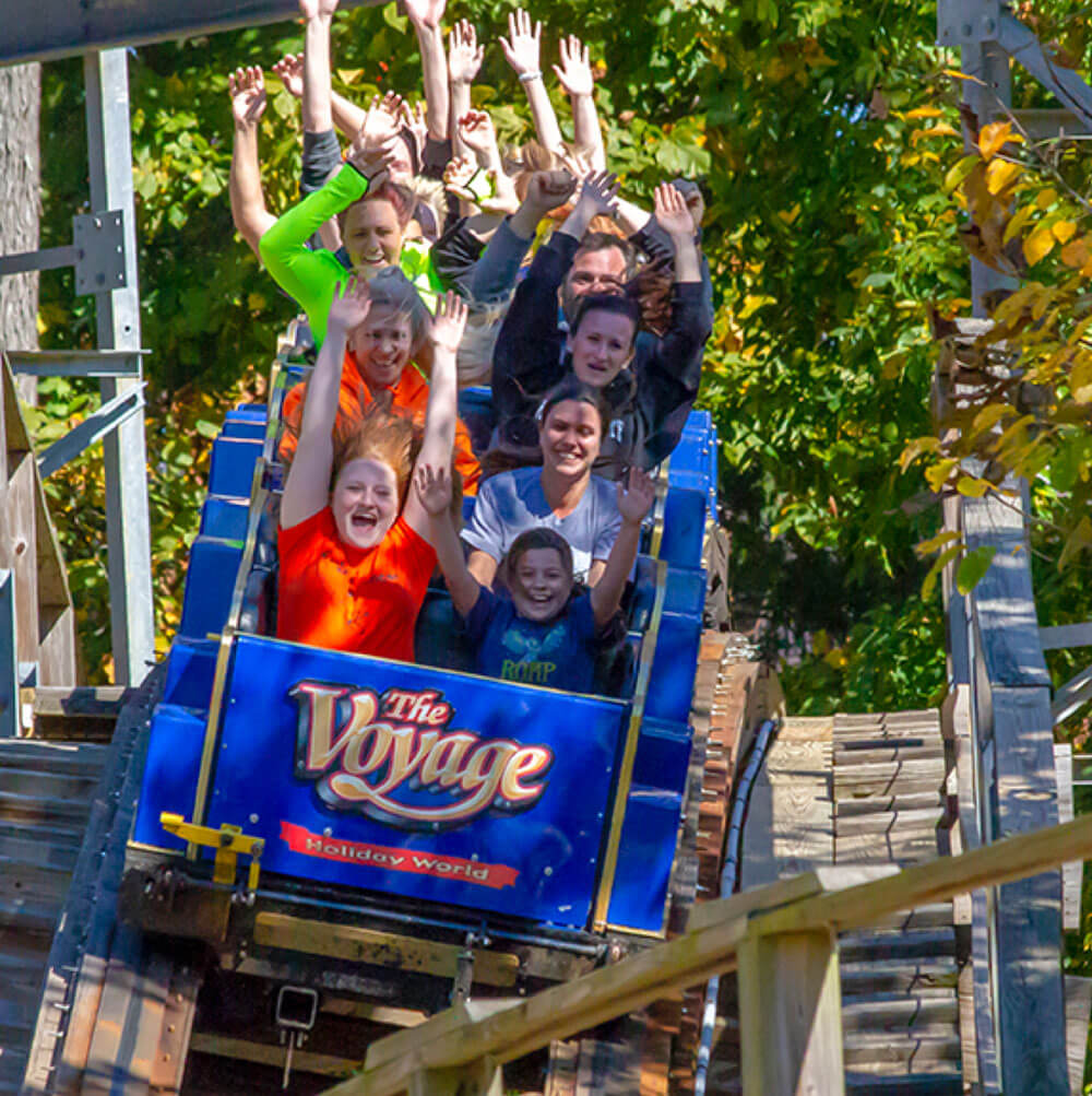 Guests screaming with their hands up on Voyage Wooden Roller Coaster at Holiday World.