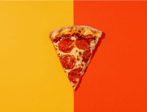 A slice of pepperoni pizza on a colorful background at Holiday World & Splashin' Safari in Santa Claus, Indiana.