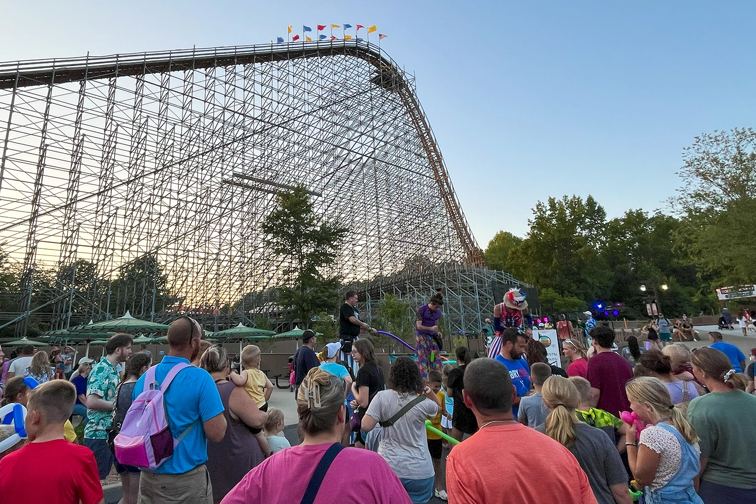 Atmosphere of Friday Night Live! as stilt walkers and Happy New Month entertain Guests near The Voyage at Holiday World.