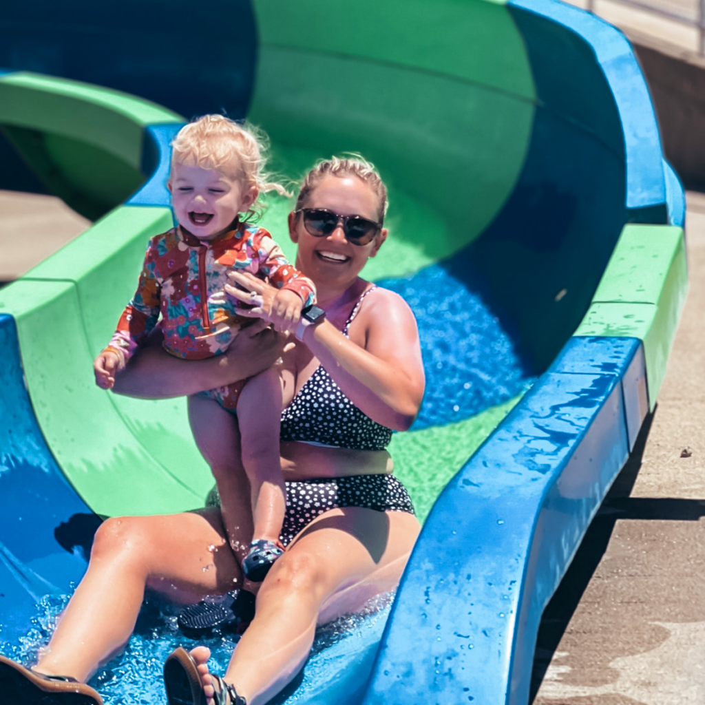 HoliBlogger Jackie and her daughter slide down a slide.