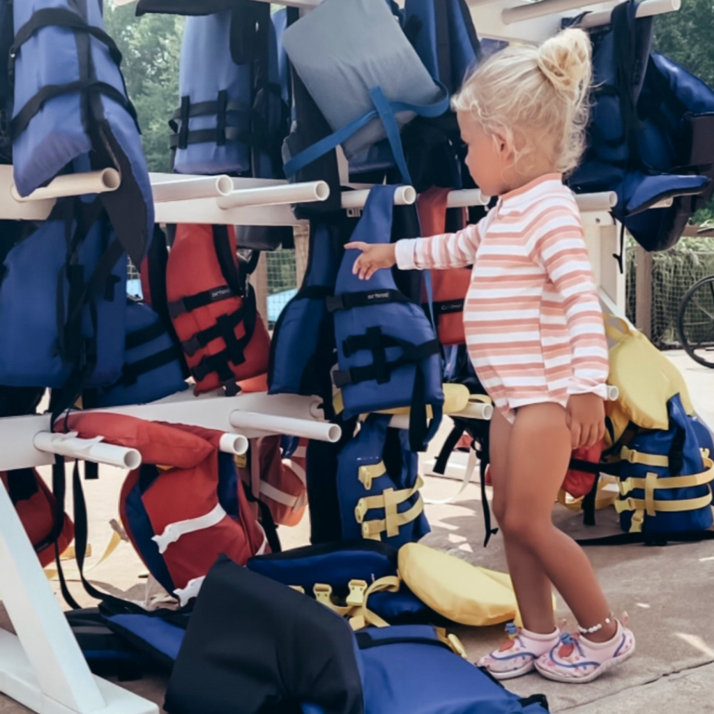 HoliBlogger Jackie's daughter chooses a life jacket to wear.