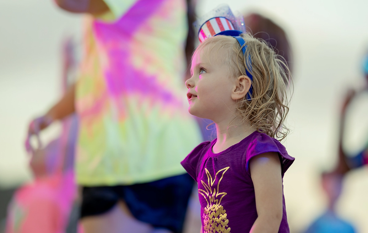 A young girl looking on in amazement during the Light the Night DJ Dance Party at Holiday World.