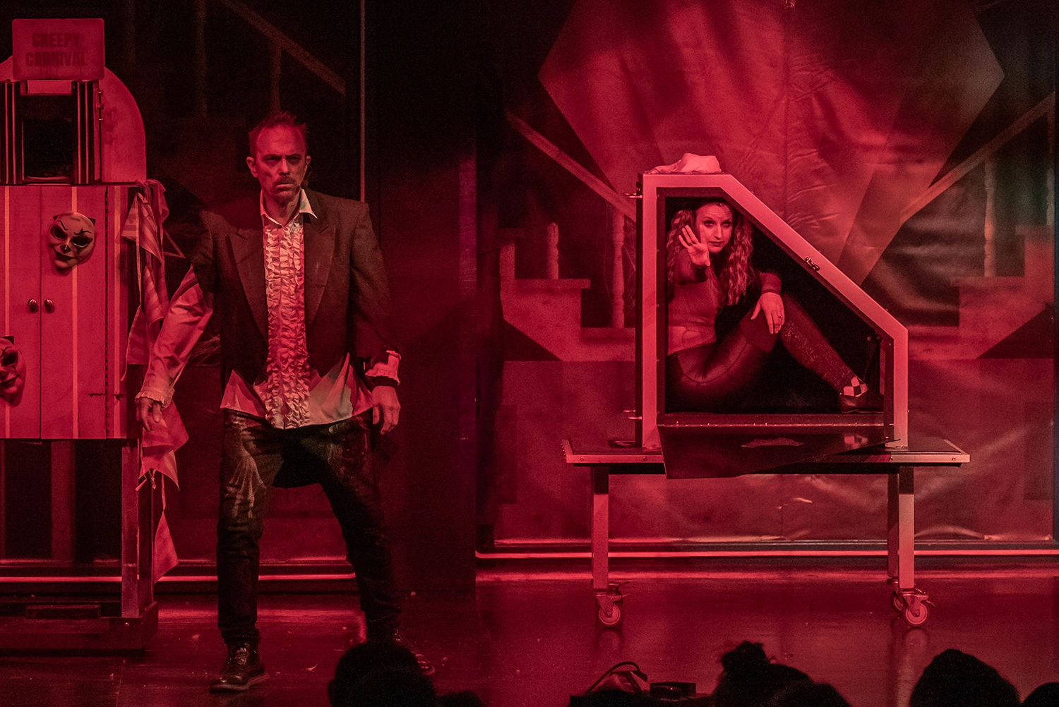 The assistant waves goodbye before being locked in a box during Magic of the Night at Holiday World's Friday Night Live!