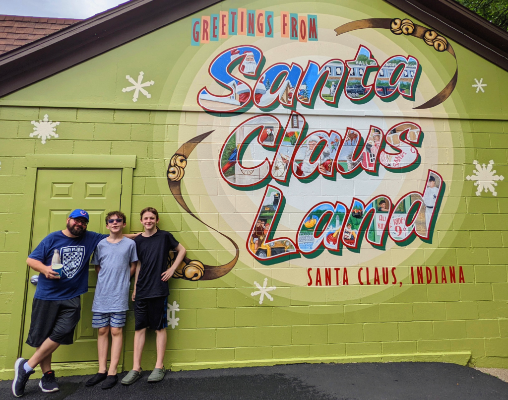 Paula and his sons by the Santa Claus Land Mural