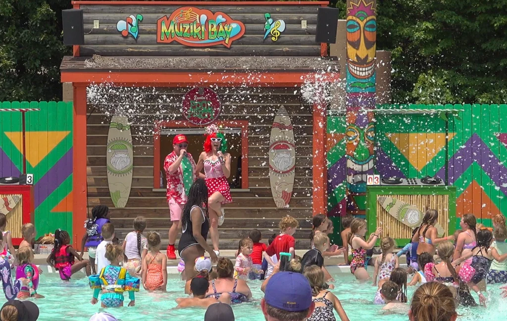 Snowing in summer during Santa's Pool Party at Muziki Bay in Splashin' Safari.