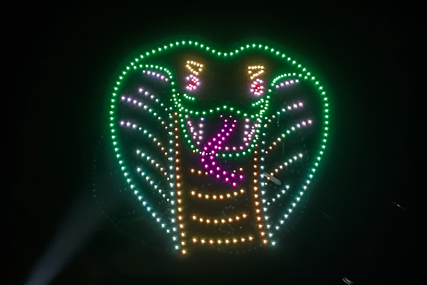 The head of a snake formed by drones during Halloween in the Sky at Holiday World.